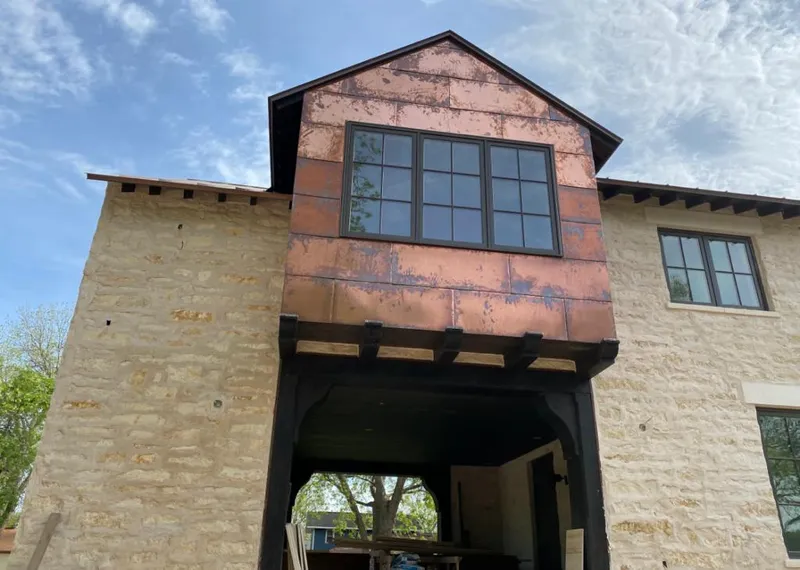Copper metal panel facade on a stone building for Skylight Installation in Hoosick